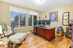 Office area with light hardwood / wood-style flooring