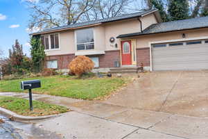 View of front facade with a garage and a front yard