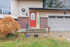 View of exterior entry featuring a garage