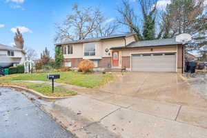 View of front of home with a front yard and a garage