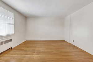 Spare room with light wood-type flooring and radiator