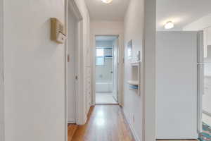 Hall featuring light wood-type flooring