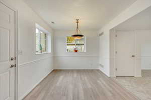 Unfurnished dining area featuring light hardwood / wood-style floors