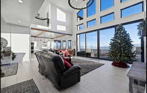 Living room featuring high vaulted ceiling and light hardwood / wood-style floors