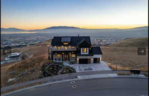 View of front of house with a mountain view and a garage