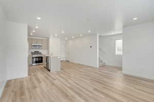 Great room featuring light wood-type flooring.