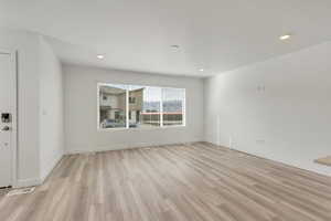 Great room featuring light hardwood / wood-style flooring and a textured ceiling