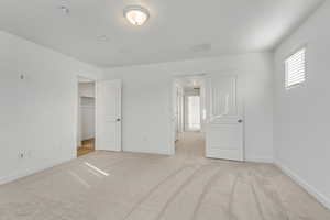 Spacious bedroom with light carpet, a closet, and closet