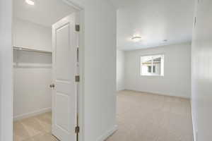 Hallway with light colored carpet