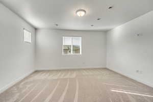 Bedroom with light colored carpet