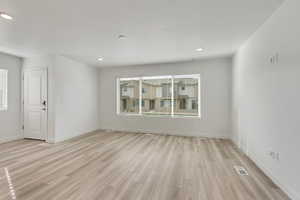 Great room featuring light hardwood / wood-style floors. Huge window!