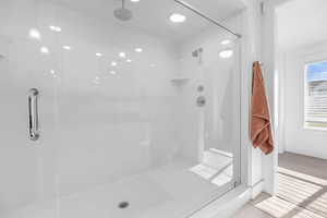 Bathroom with tile patterned flooring and an enclosed shower