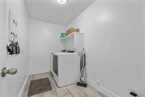 Clothes washing area with independent washer and dryer and a textured ceiling