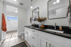 Bathroom with tile patterned flooring, vanity, and toilet