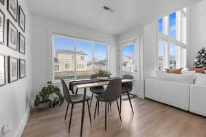 Dining area featuring a wealth of natural light and light hardwood / wood-style flooring