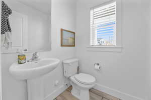 Bathroom with hardwood / wood-style floors and toilet