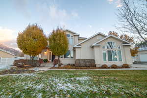 View of front of property with a lawn