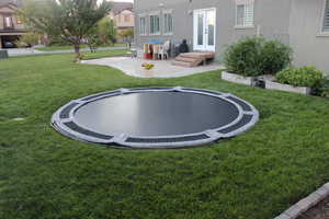 View of yard featuring a trampoline