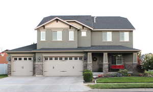 View of front facade featuring a front yard, a porch, and a garage