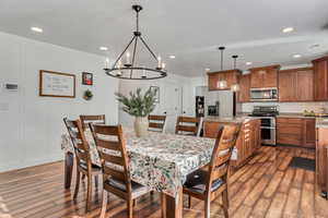 Dining space featuring a chandelier and dark hardwood / wood-style floors