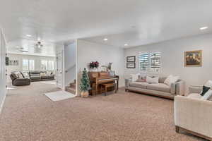 Living room with carpet flooring and plenty of natural light