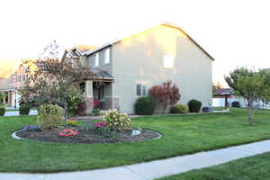 View of home's exterior with a yard and central AC