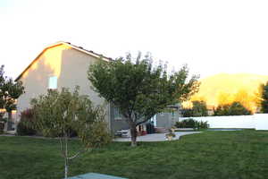 Yard at dusk featuring a patio