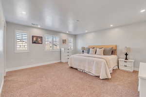 Bedroom with light colored carpet