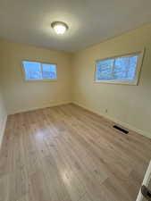 Unfurnished room with light hardwood / wood-style flooring