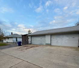 View of front facade featuring an outbuilding and a garage