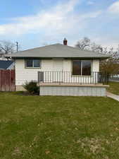 Back of house featuring a yard