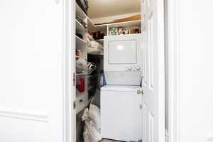 Laundry room with stacked washer and clothes dryer