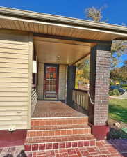 Doorway to property with covered porch