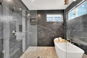 Bathroom with independent shower and bath and tile walls