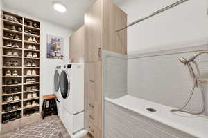 Clothes washing area featuring cabinets, separate washer and dryer, and light hardwood / wood-style floors