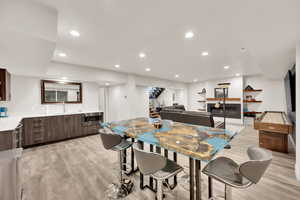 Dining area with light hardwood / wood-style flooring and sink