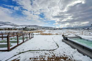 View of dock featuring a jacuzzi and a mountain view