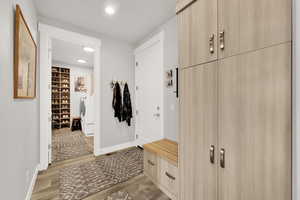 Mudroom featuring hardwood / wood-style flooring and washer and dryer