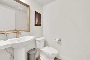 Bathroom with wood-type flooring and toilet