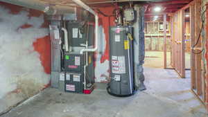 Utility room featuring heating unit and water heater