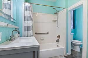 Full bathroom featuring shower / bath combination, new vanity, sink and toilet with LVP flooring