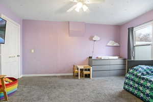 Carpeted bedroom with ceiling fan