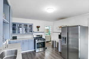 Remodeled kitchen with backsplash, sink, upgraded quartz countertops, cabinets, stainless steel appliances and LVP floors