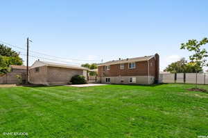 Back of property with a patio area and a lawn