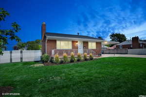 View of front of house with a carport and a front lawn