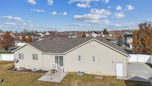 Back of property featuring a yard and a patio area