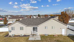 Back of property with a yard and cooling unit