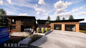 View of front of property with a garage and an outbuilding