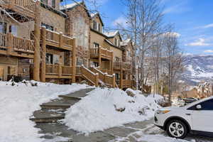 Snow covered property with a mountain view