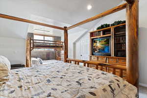 Bedroom featuring carpet flooring, a textured ceiling, and vaulted ceiling